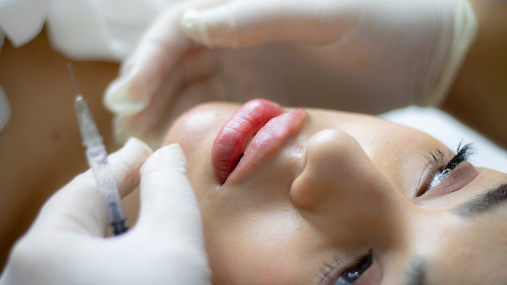 <strong>A Closer Look At The Aesthetic Industry's Future: Here's What We Need To Know</strong> 1 Woman receiving dermal fillers at a licensed aesthetic clinic.