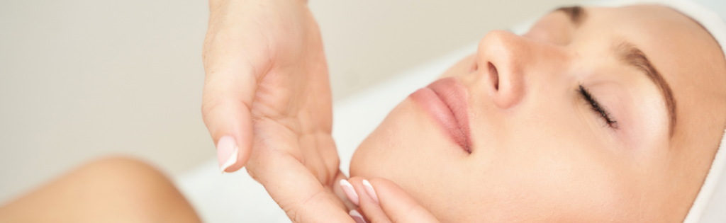Female client enjoying a professional facial massage for skin rejuvenation.