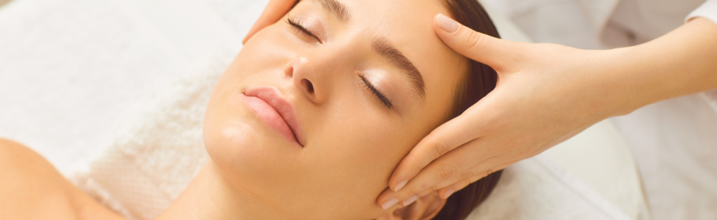 Calming skincare treatment: woman undergoing facial massage therapy.