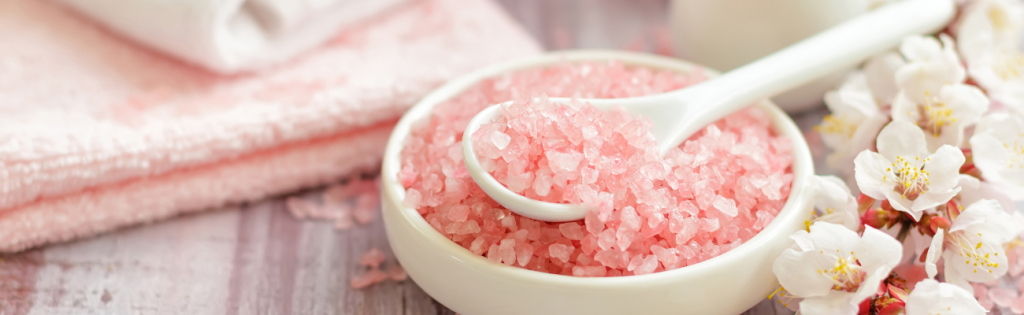 Decoding the Mysteries of Aesthetic Clinics: Med Spas, Dermatology Centres, and Beyond! 1 Luxurious aesthetic clinic room with a treatment bed, towels, and ambient lighting for a relaxing client experience.