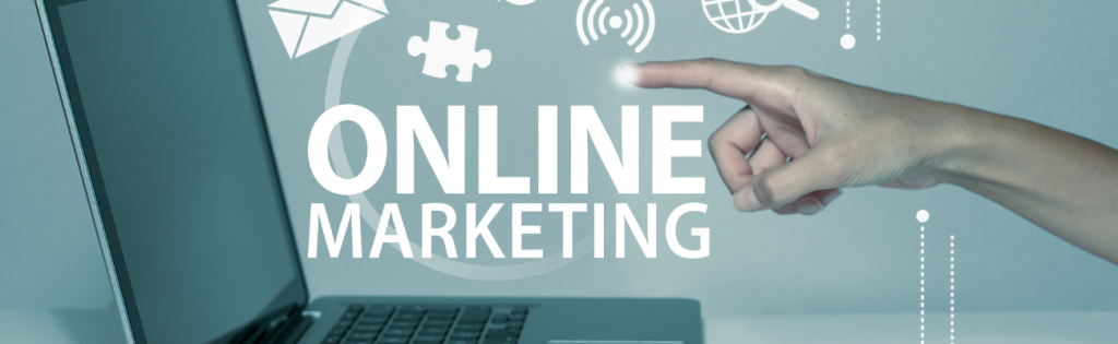 a hand touching a laptop with the words online marketing