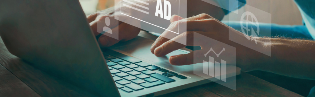 a person's hand typing on a laptop.