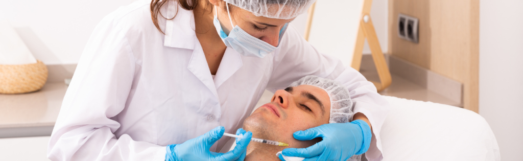 Aesthetic practitioner administering jawline filler to enhance facial contours.