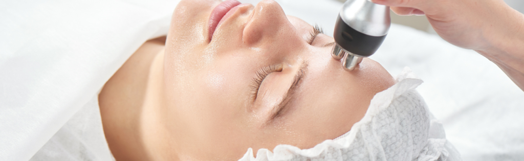 Woman receiving RF (radiofrequency) treatment on face in a clinic setting.