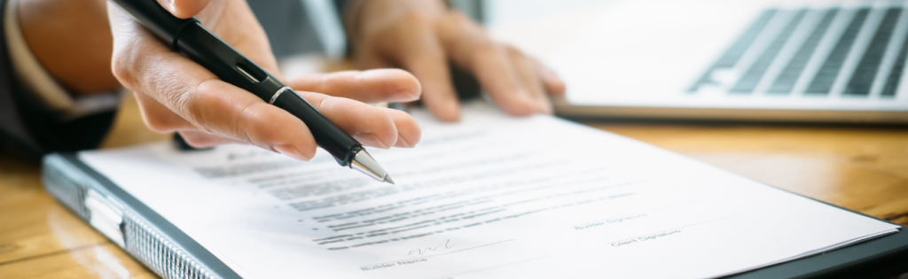 Practitioner explaining a treatment consent form to a client in a clinic.