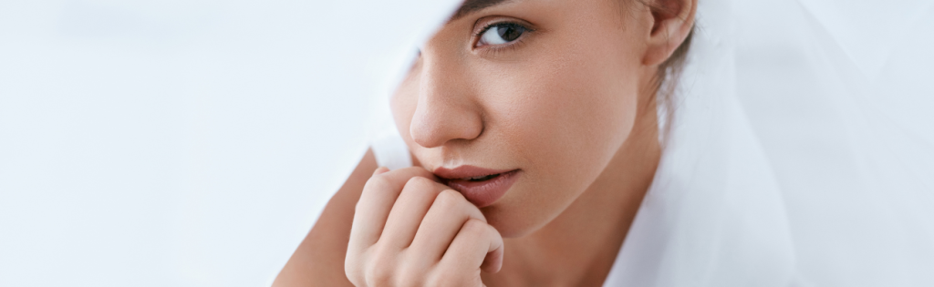 How Your Medical History Can Improve Aesthetic Results 1 Girl with flawless, glowing skin smiling confidently in natural light.