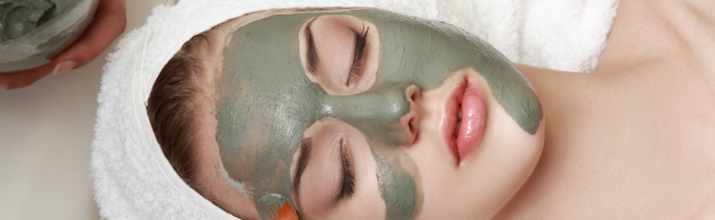 Woman relaxing with a facial mask applied during a skincare treatment.