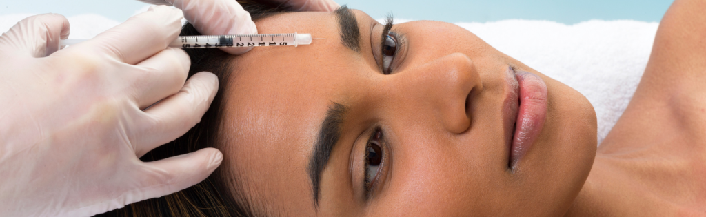 Faces | Botox, Laser Hair Removal, and More 1 Woman receiving Botox injections in a clinical setting for wrinkle reduction and facial rejuvenation.