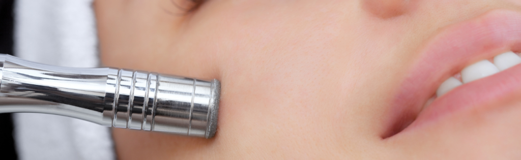 Faces | Botox, Laser Hair Removal, and More 2 Woman receiving a microdermabrasion treatment in a professional clinic to exfoliate and rejuvenate her skin.