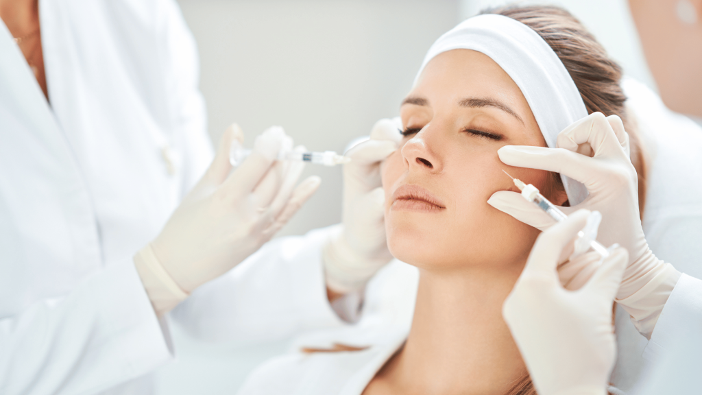Unleash Your Aesthetic Clinic's Potential: The Ultimate Guide to Building a Skilled Team! 1 Aesthetic practitioners administering dermal fillers to a client in a clinical setting.