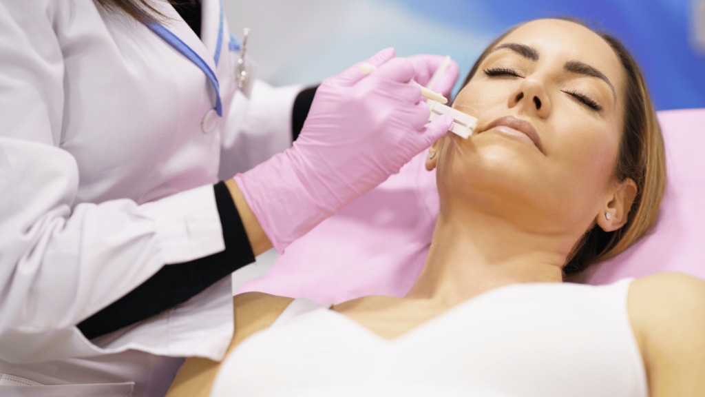 Aesthetic practitioner marking up a patient’s face before a cosmetic treatment in a clinical setting.