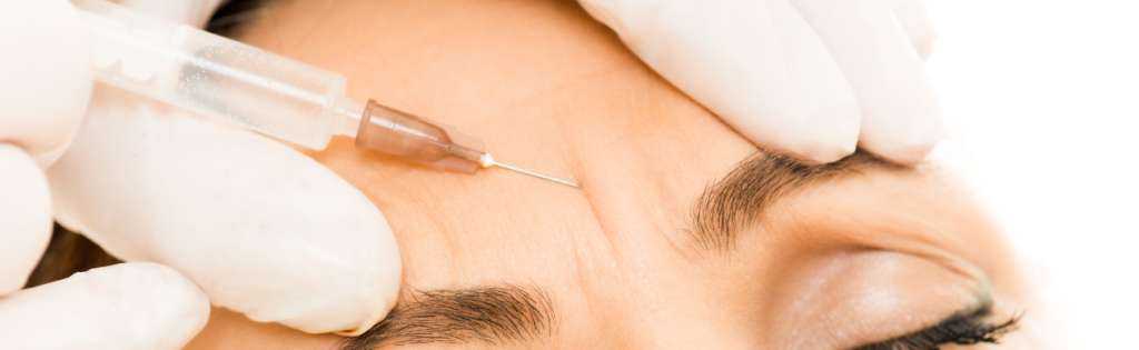Faces | What to Expect in a Botox Consent Form with Faces Consent App 2 Close-up of a professional administering a botox injection to smooth forehead wrinkles, with gloved hands carefully positioning the needle.
