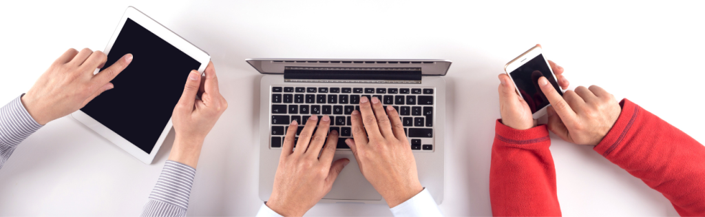 <strong>Getting More Business for Your Cosmetic Business: Effective Promotional Strategies</strong> 2 Practitioners holding smartphones and laptop displaying social media apps, with a laptop open to an analytics dashboard on a desk.