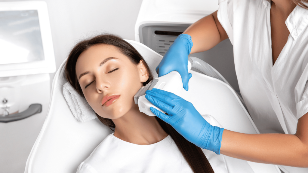 Woman undergoing IPL facial treatment at an aesthetic clinic.