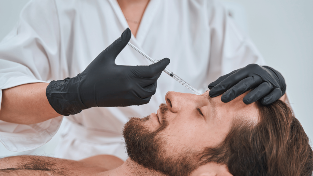 Faces | What Sets Apart Leading Aesthetic Practitioners From the Rest 1 Male client receiving dermal filler treatment from a qualified aesthetic practitioner.