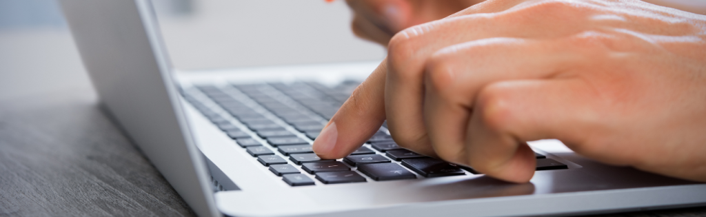 A client using a laptop to make an online payment for a beauty treatment.
