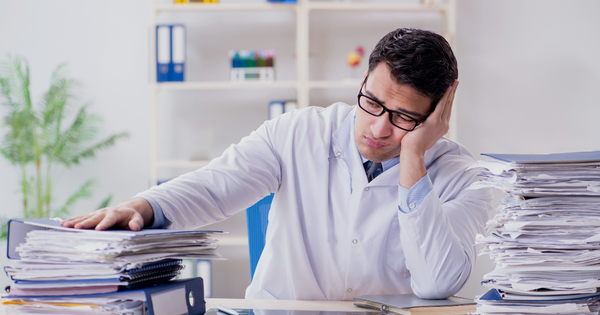 5 Guaranteed Tips to Efficiently Start and Run an Aesthetic Clinic! 2 Practitioner looking stressful looking at papers or numbers